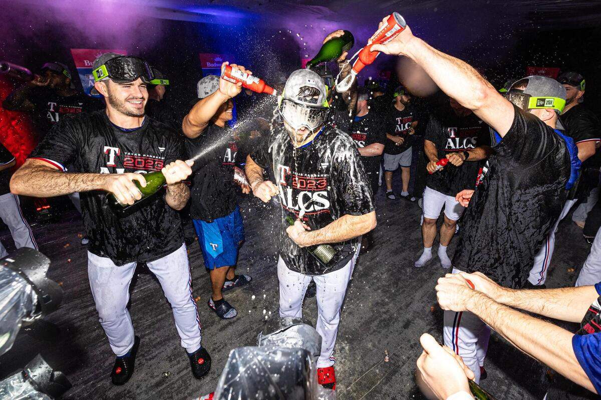 Texas Rangers pitcher Nathan Eovaldi gets beer and champagne poured on him while celebrating a win in game three to clinch the ALDS between the Texas Rangers and Baltimore Orioles at Globe Life Field in Arlington on Tuesday, Oct. 10, 2023.