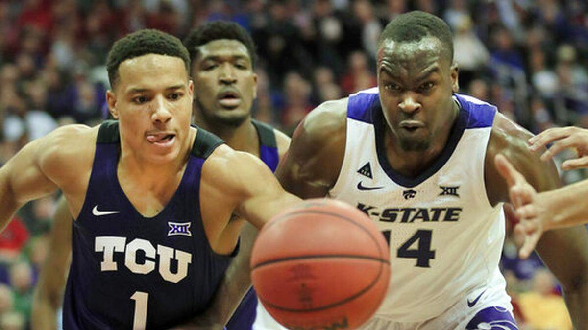 TCU guard Desmond Bane (1) and Kansas State forward Makol Mawien (14) chase a loose ball during the first half of an NCAA college basketball game in the quarterfinals of the Big 12 conference tournament in Kansas City, Mo., Thursday, March 14, 2019. (AP Photo/Orlin Wagner)