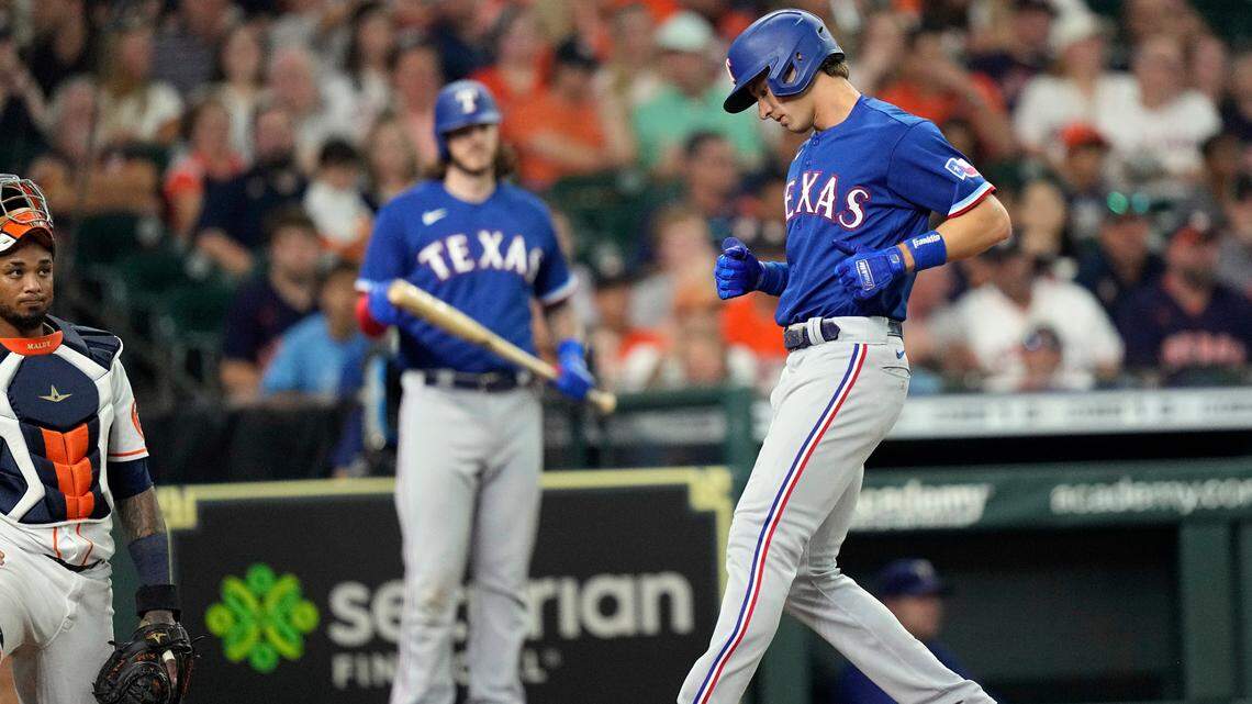 Rangers rookie outfielder Eli White scores after smashing his first major league home run in the third inning Wednesday against the Astros. White added another homer in the seventh.