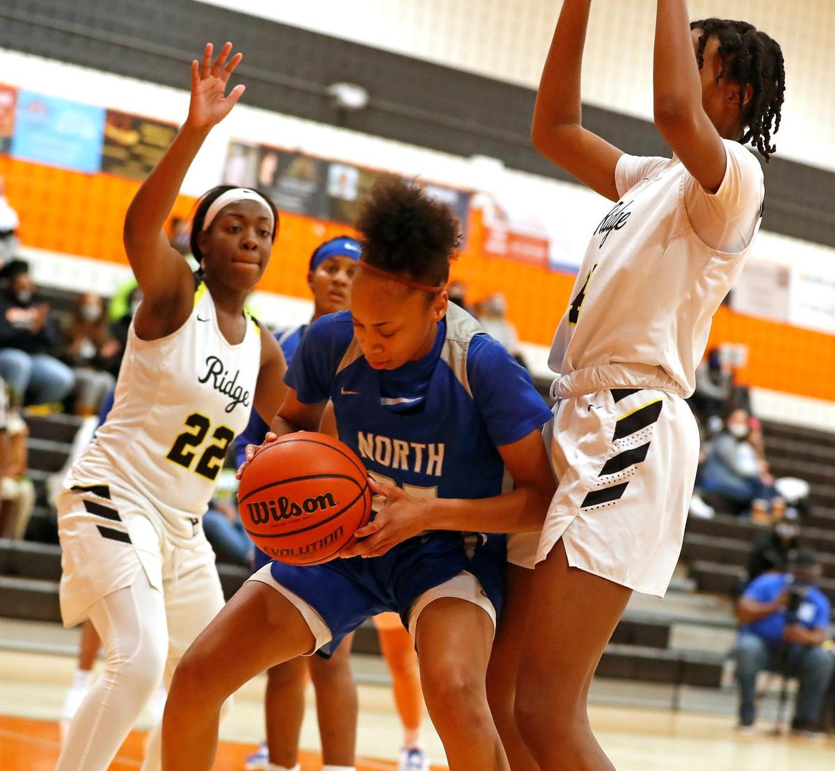 North Crowley center Maiyah Watkins (25) is pressured by Fossil Ridge’s Zaria Brown (22) and Jade Masagayo (14) during the second half of a 6A Region 1 Bi-district girls basketball game at Haltom High School in Haltom City, Texas, Friday, Feb. 12, 2021. North Crowley defeated Fossil Ridge 44-41. (Special to the Star-Telegram Bob Booth)