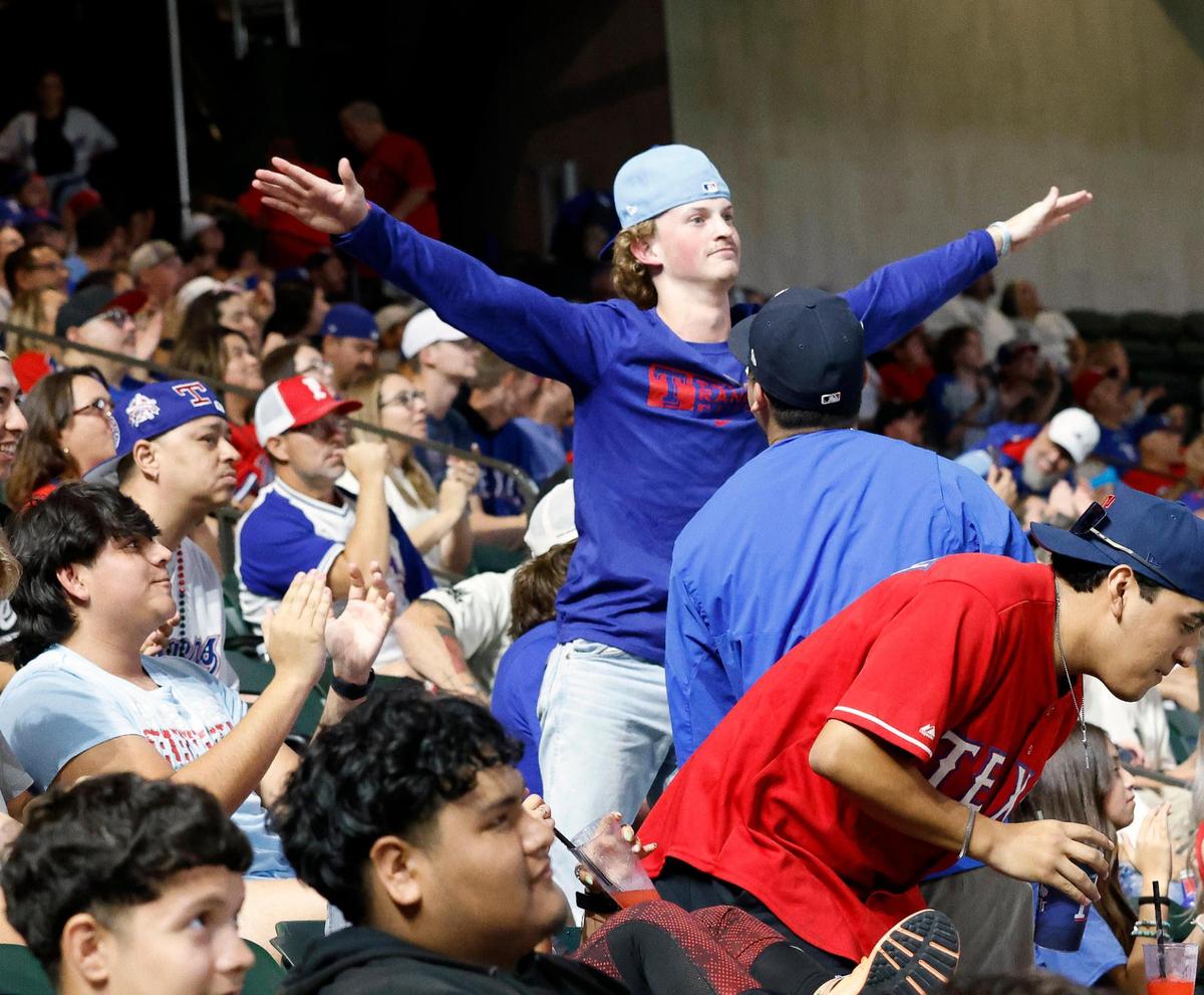 A fan signals safe on a stolen base during the ACLS game 7 watch party at Globe Life Field in Arlington, Texas, Friday, Oct. 23, 2023. Rangers led 4-1 in the top of the third. (Special to the Star-Telegram Bob Booth)