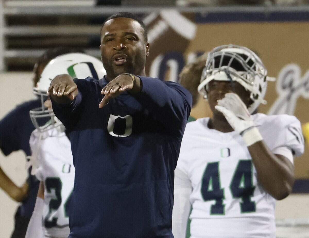 Oakridge head coach Jeromy Flowers sends in a signal to the defense during the first half of the SPC 2025 3A Football Championship football game between The Oakridge School and Fort Worth Country Day at Mavericks Stadium in Arlington, Texas, Saturday Nov. 08, 2025.