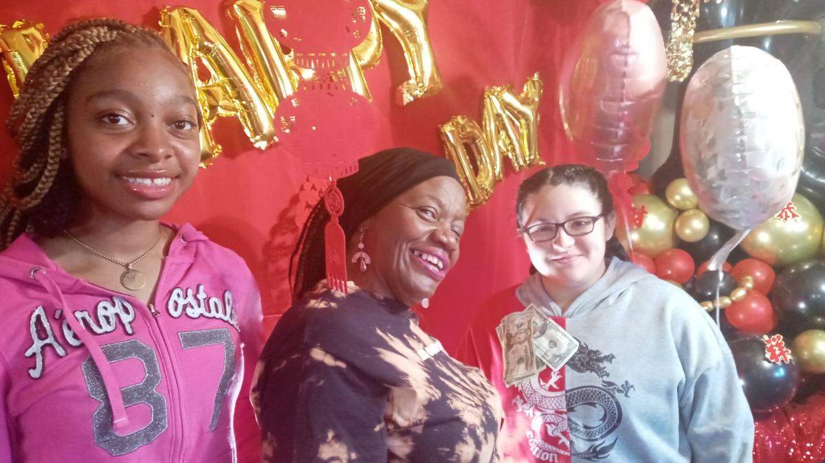 Edna Jackson (center) shown with a couple of young ladies in her Inner Princess Program wishing her a happy birthday, has devoted herself to helping underprivileged youths in the route to a better education.