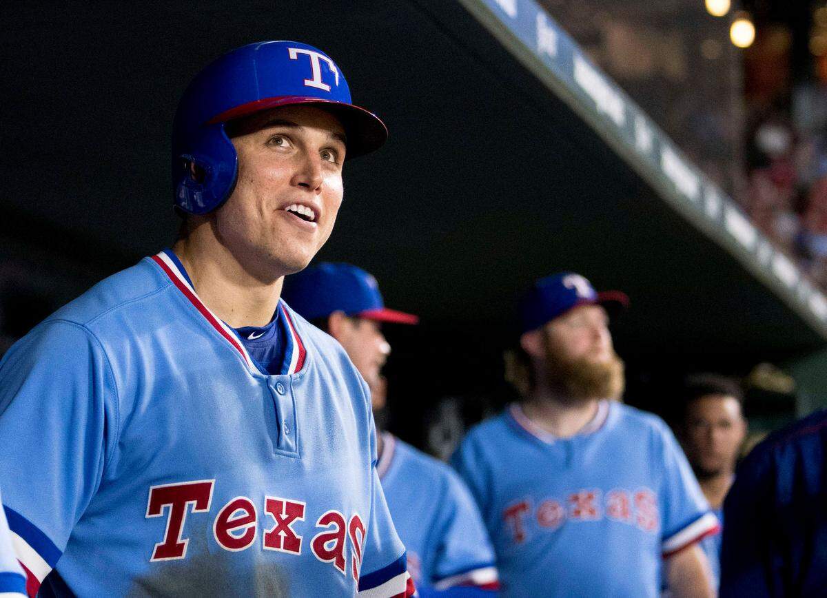 Texas Rangers left fielder Drew Robinson (18) checks out the replay screen after he hits a two run home run against the Los Angeles Angels during the sixth inning at Globe Life Park in Arlington.
