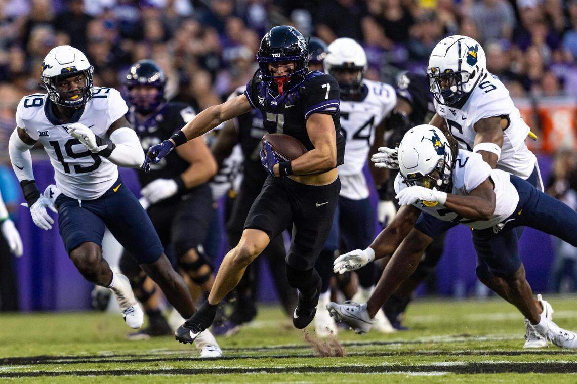 TCU wide receiver JP Richardson (7) evades West Virginia defenders on his way to score a touchdown in the first quarter of a Big XII conference game between the TCU Horned Frogs and the West Virginia Mountaineers at Amon G. Carter Stadium in Fort Worth on Saturday, Sept. 30, 2023.
