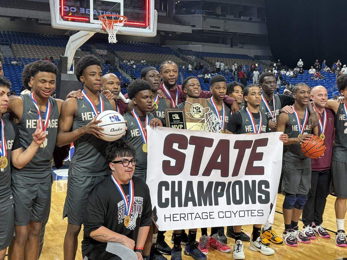The Frisco Heritage basketball team poses with hardware after defeating Beaumont West Brook in the Class 5A Division I state championship game on Saturday, March 14, 2026, at the Alamodome in San Antonio, Texas.