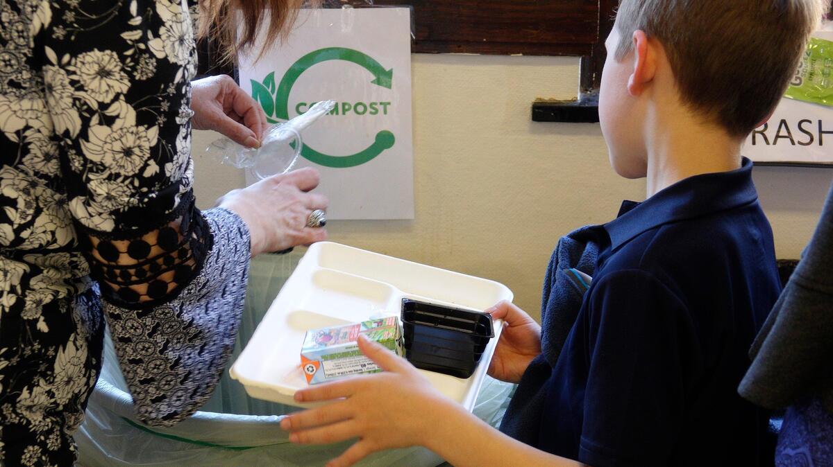 A student prepares to deposit his paper lunch tray into the compost bin, the last stop for anything that isn’t trash or recyclable. Students at North Hi Mount Elementary School in Fort Worth are taking part in the Share Table Project.