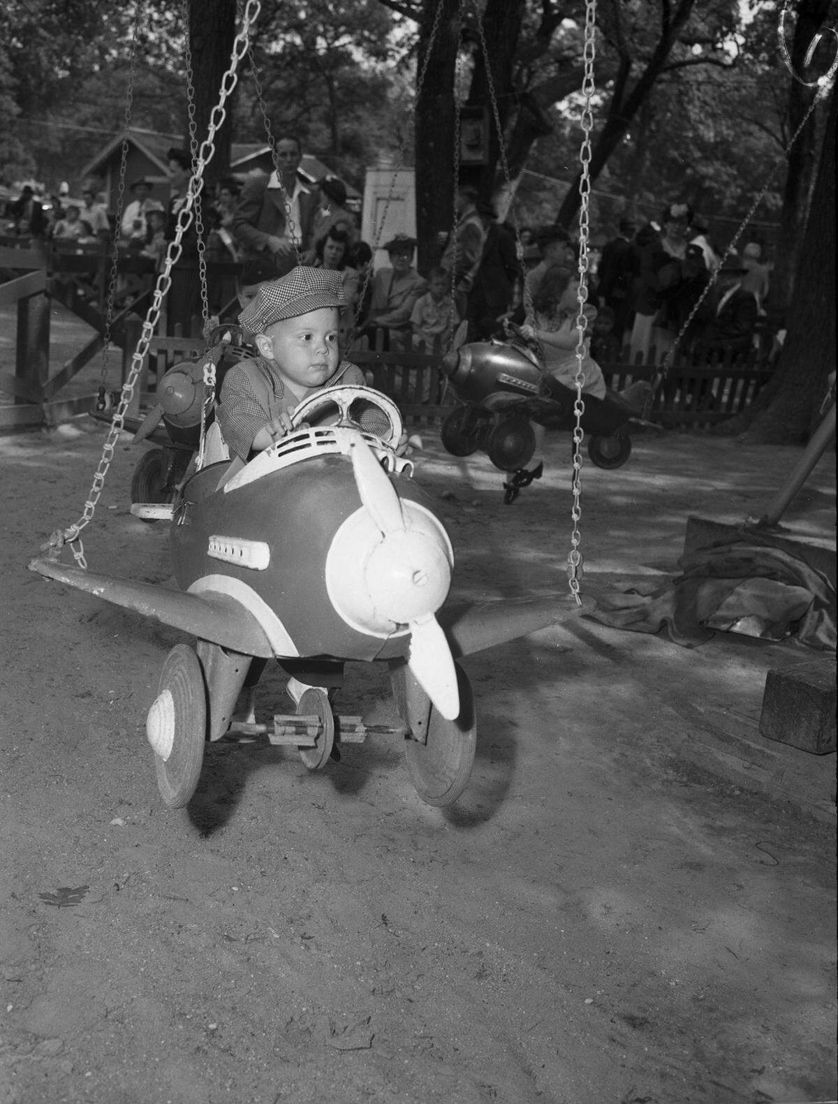 April 7, 1945: The Forest Park Zoo opened Sunday to a big crowd. Sitting steady at the controls is a serious young aviator Larry Martin Male. He is the 3-year-old son of Mr. and Mrs. Tom R. Male.