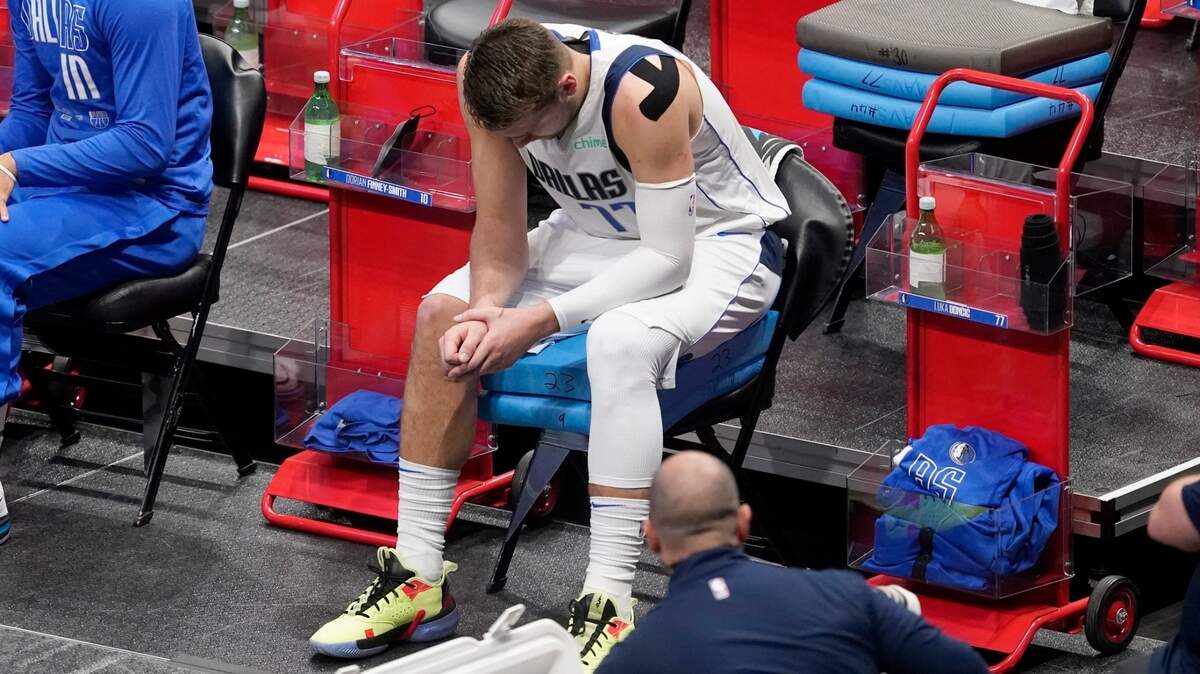 Dallas Mavericks guard Luka Doncic sits on the sideline in the first half in Game 4 Sunday night at American Airlines Center. The Los Angeles Clippers evened the best-of-7 series with a dominating win. Doncic was playing with a strained neck.