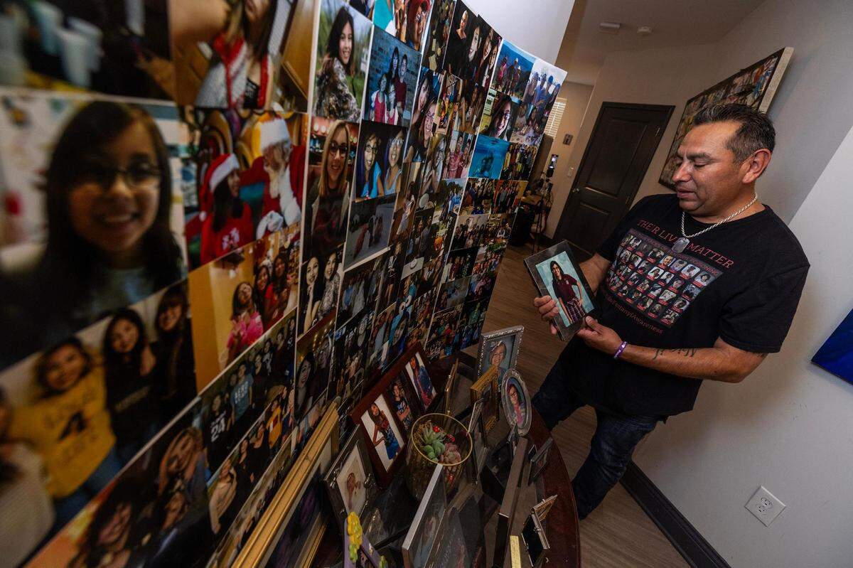 Adolph Alvarez looks at photos at an altar for his daughter Abigil, who died from fentanyl poisoning on May 14, 2022, at 18 years of age.