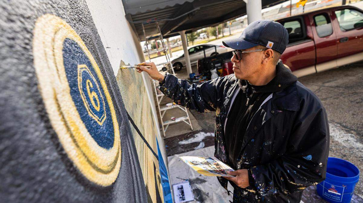 Artist Armando Castelan finishes a mural paying homage to the history of Black cowboys and railroad workers in Fort Worth on the outside of Blank Space Fort Worth.