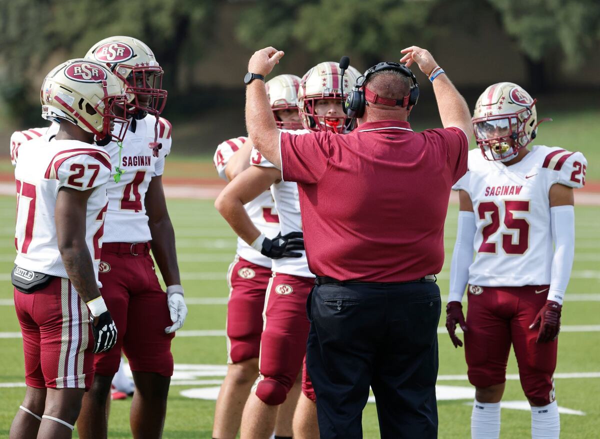 Saginaw head coach Mike Peters talks to the team during a possession change during a UIL football game at Farrington Field in Fort Worth Saturday, Sept. 14, 2024.