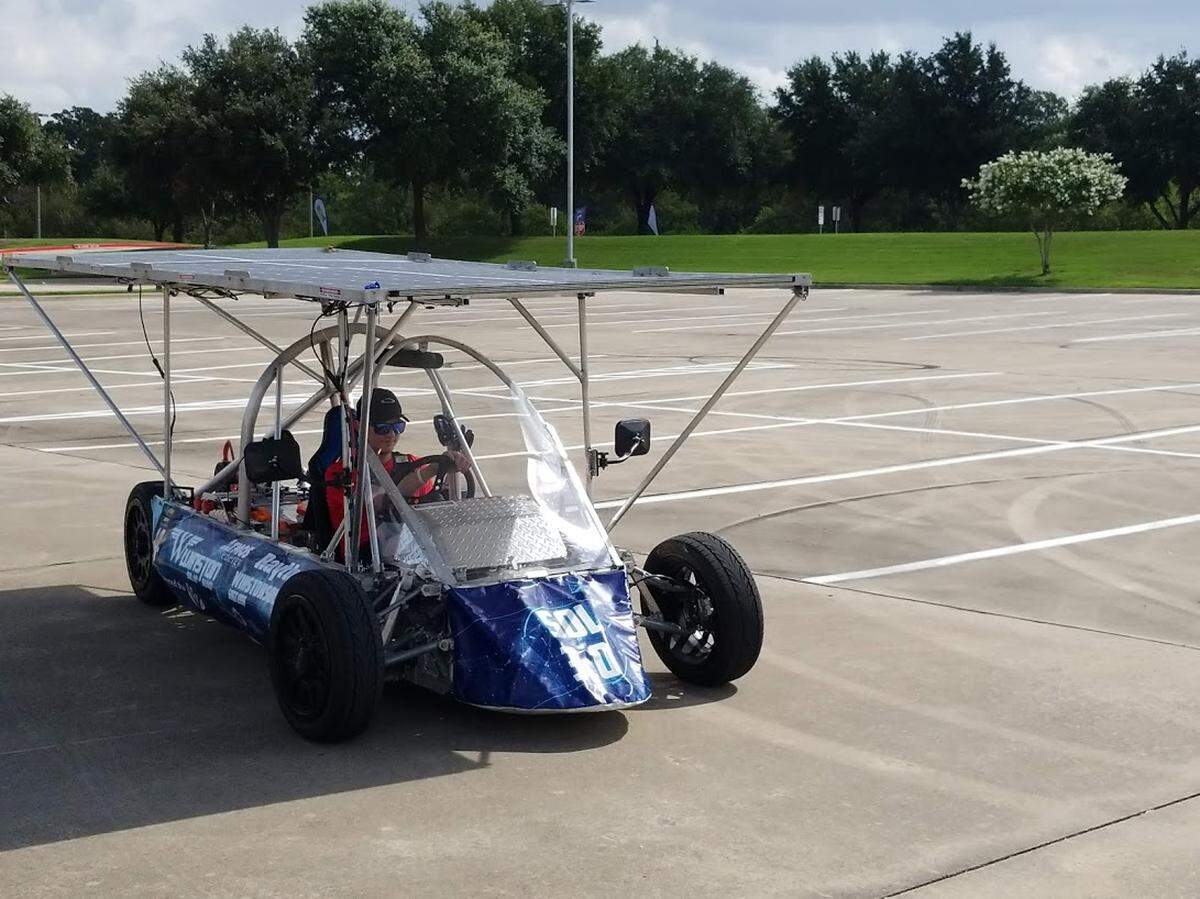 Jacob Timmons, a junior at The Winston School in North Dallas, is the co-captain of the Solar Car Academy. He drove his team’s solar-powered car through the parking lot Saturday at the National Drive Electric Week event in Irving.