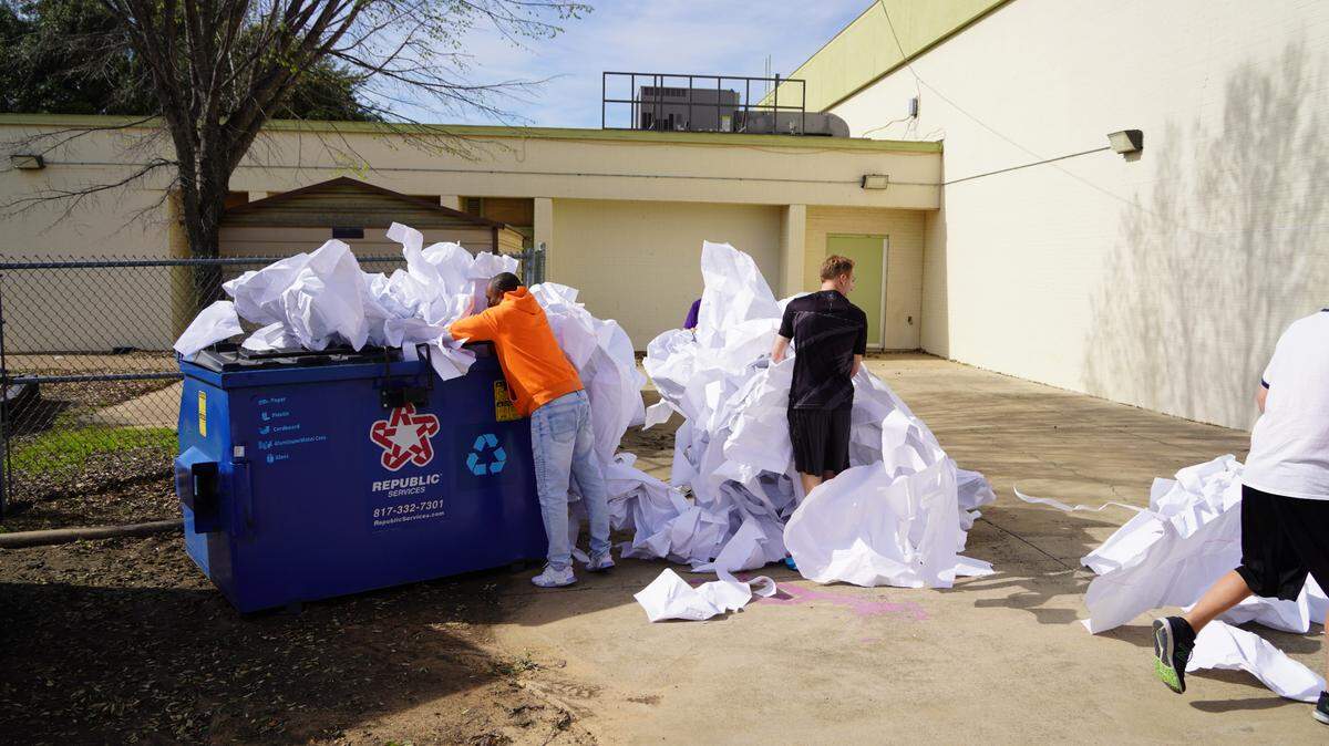 Pieces of the world’s largest paper snowflake attempt are seen being thrown away outside the Martin Luther King Jr. Community Center.