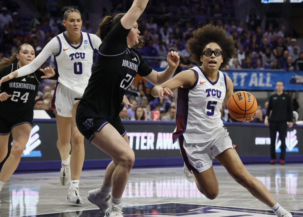 TCU guard Olivia Miles (5) turns into the paint in front of Washington forward Brynn McGaughy (21) during the first half of a second round NCAA Division I Women's Basketball Championship game at Schollmeier Arena in Fort Worth, Texas, Sunday, March, 22, 2026.