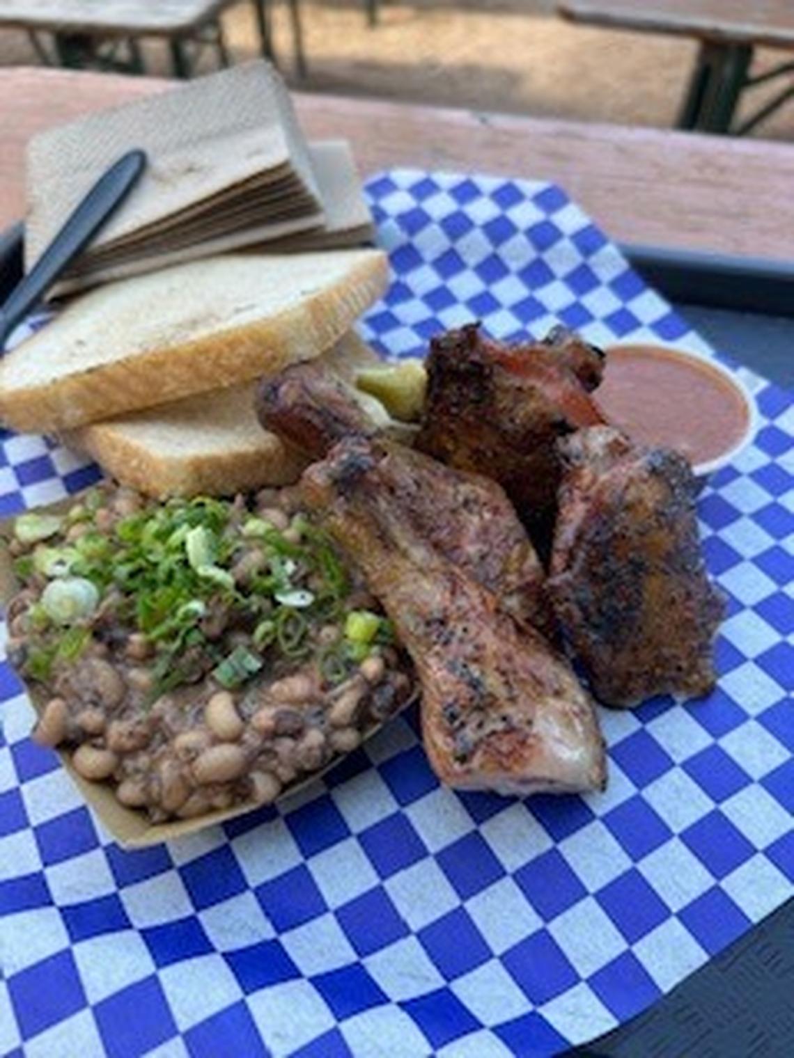 Chicken leg quarter and chili vinegar dip with burnt ends & black eyed peas at Distant Relatives in Austin. 