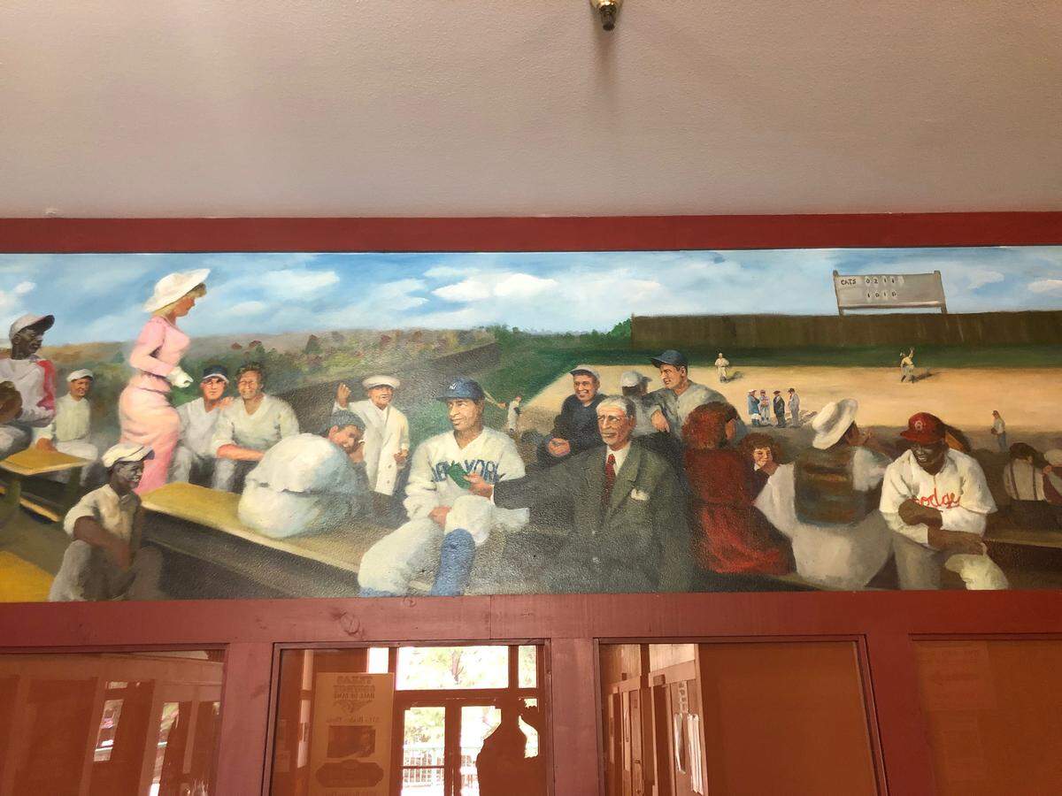One mural depicts Major League Baseball stars at a Fort Worth Cats game.