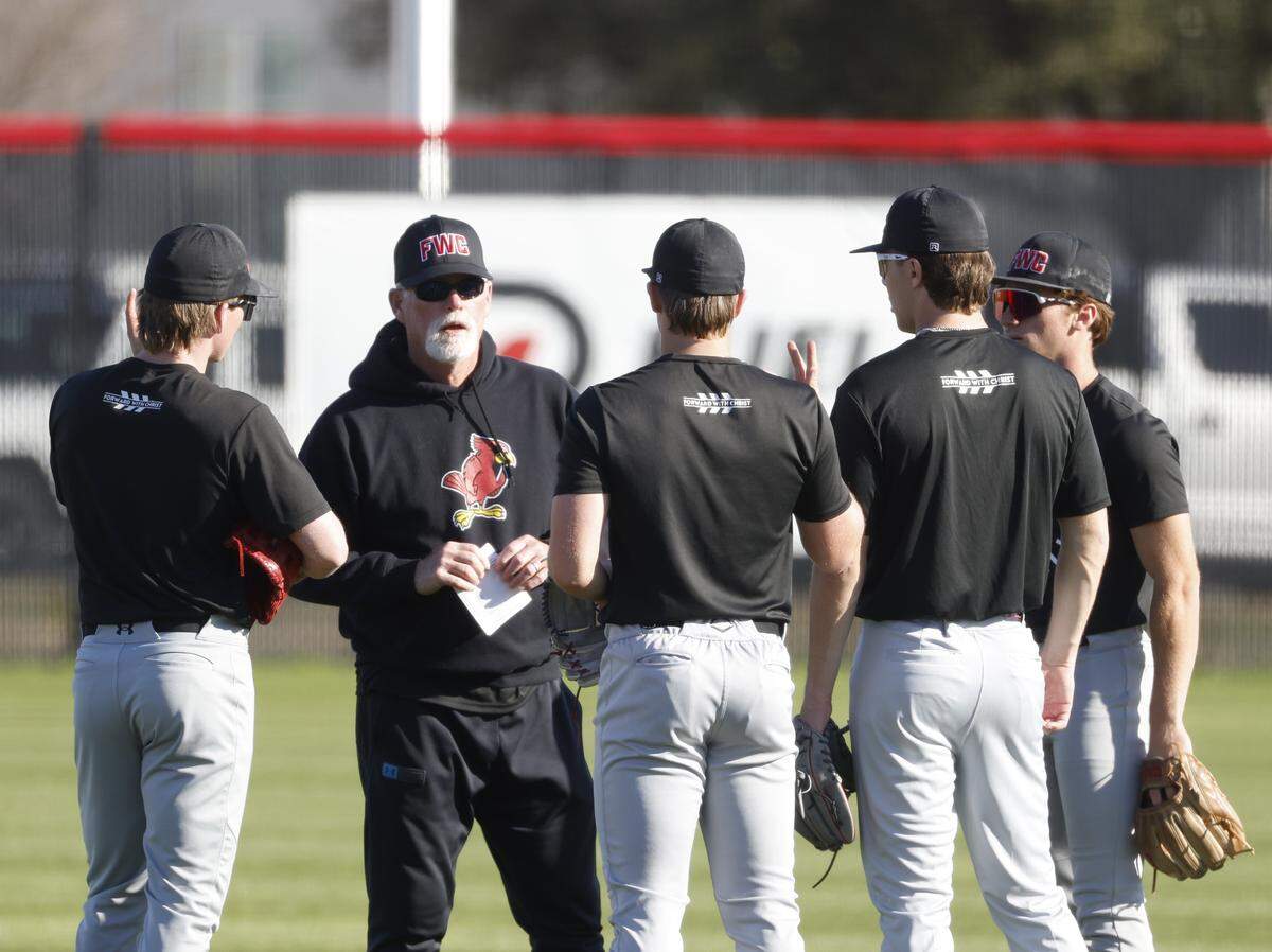 Fort Worth Christian head baseball coach Rusty Greer talks to players at the mound during baseball practice at Fort Worth Christian School in North Richland Hills, Texas, Monday Feb. 23, 2026.
