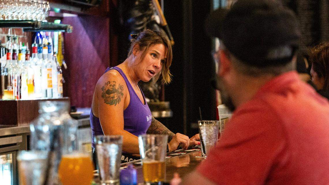 Bartender Taylor Turman speaks with customers sitting in the bar at the Flying Saucer in downtown Fort Worth on Monday, July 29, 2024.