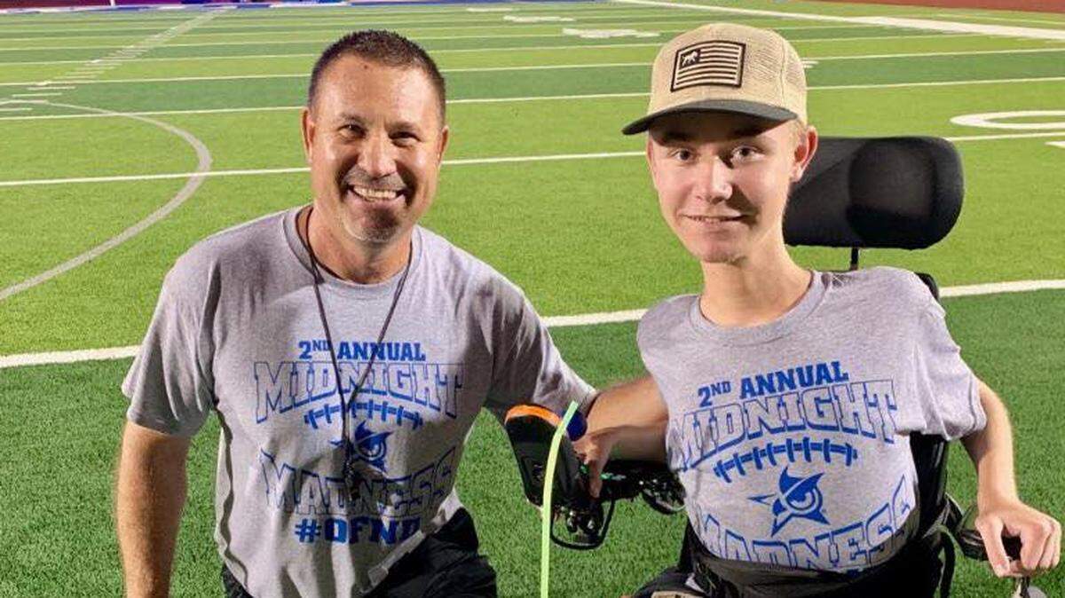 Joshua head football coach Gary Robinson (left) and junior student assistant coach Josh Pfleuger, who has Duchenne Muscular Dystrophy.