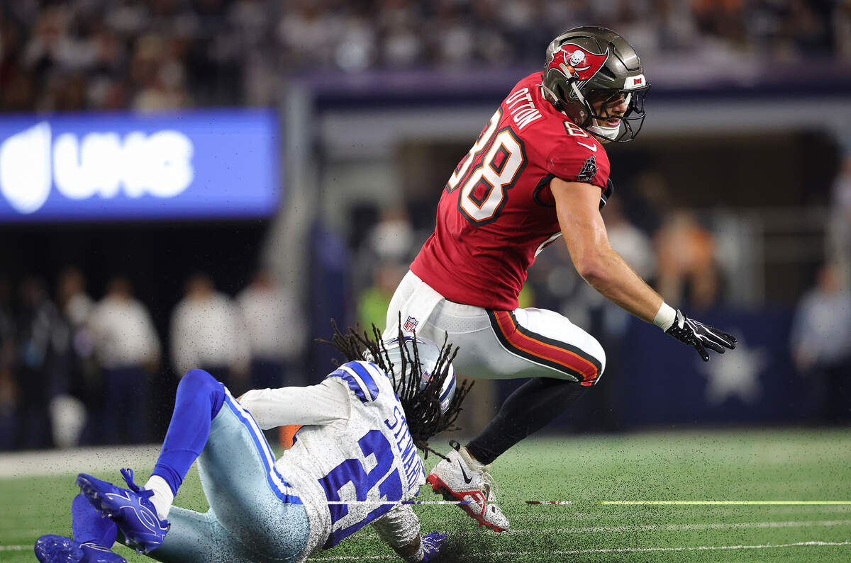 Tampa Bay Buccaneers tight end Cade Otton (88) eludes Dallas Cowboys cornerback Reddy Steward on Thursday, Oct. 8, 2026, at AT&T Stadium in Arlington.