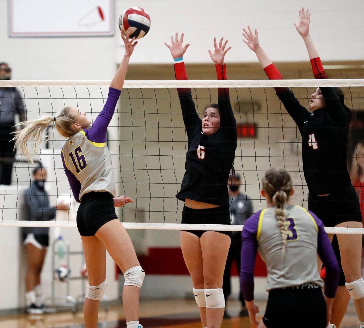 Granbury’s Kassidy Kirkpatrick tips a ball into the defense of Martin’s Courtney Hanson and Emily Adams during a high school volleyball match at Martin High School in Arlington, Texas, Tuesday, Sept. 29, 2020. Martin Lady Warriors defeated the Granbury Lady Pirates in three straight sets. (Special to the Star-Telegram Bob Booth)