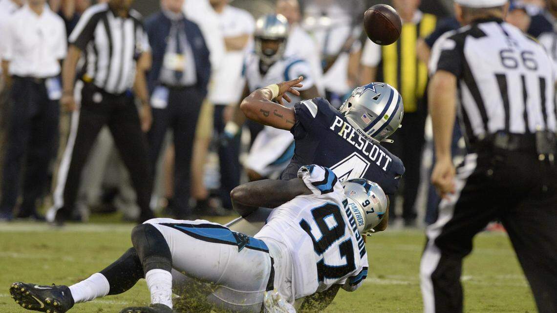 Carolina Panthers defensive end Mario Addison (97) sacks Dallas Cowboys quarterback Dak Prescott (4), causing him to fumble, late in the game on Sunday, Sept. 9, 2018 at Bank of America Stadium in Charlotte, N.C.