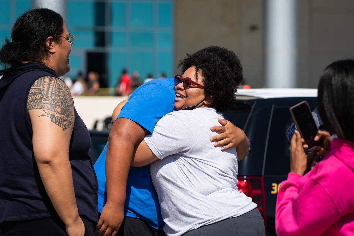 Parents pick up their children at Mansfield school district’s Center for Performing Arts after a shooting at Timberview High School Wednesday, Oct. 6, 2021, in Mansfield.