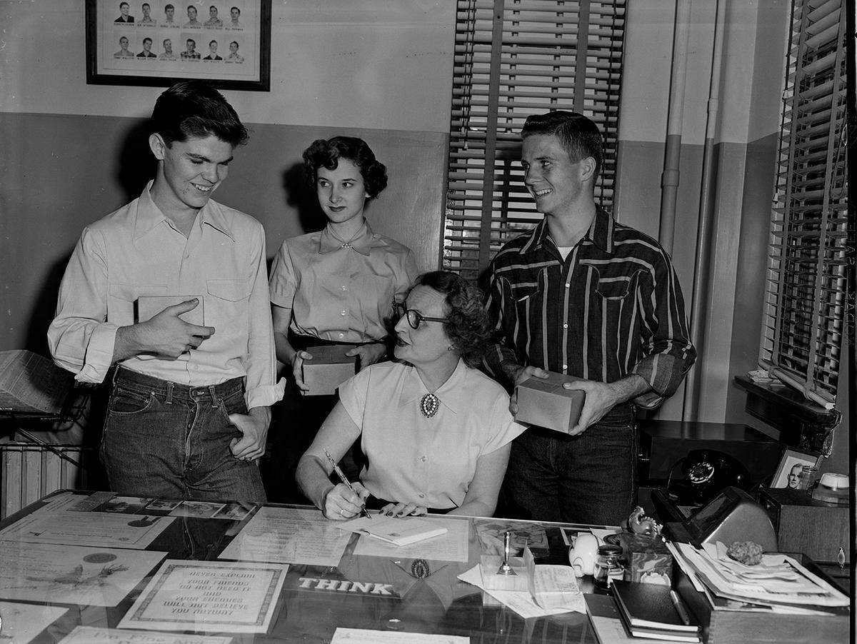 Nov. 16, 1950: Preparing postcards to invite ex-students of Paschal High School in Fort Worth to attend homecoming. From left, Dan Alexander, program chairman for the school’s courtesy council; Phyllis Cawley, council secretary; Miss Alta-Beall Blanton, faculty sponsor of the council, and Tim Jones, council vice president.