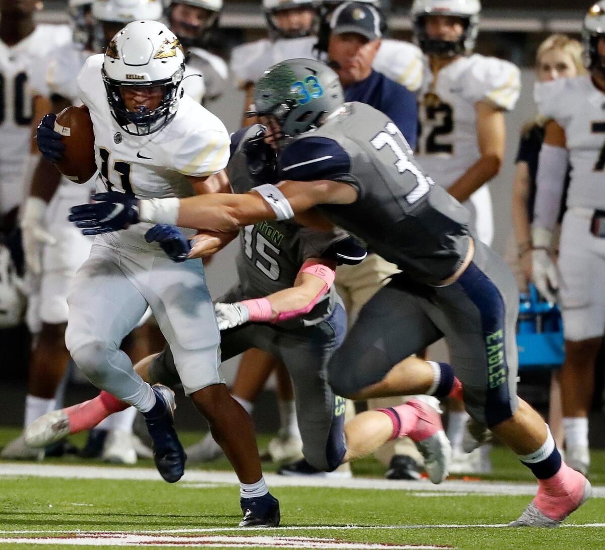 Keller wide receiver Amarion Henry (11) grabs a pass in front of Eaton safety Ben Roberts (33) in a high school district 4-6A football game at NWISD Stadium in Justin, Texas, Friday Oct. 08, 2021. Eaton defeated Keller 43-21. (Special to the Star-Telegram Bob Booth)
