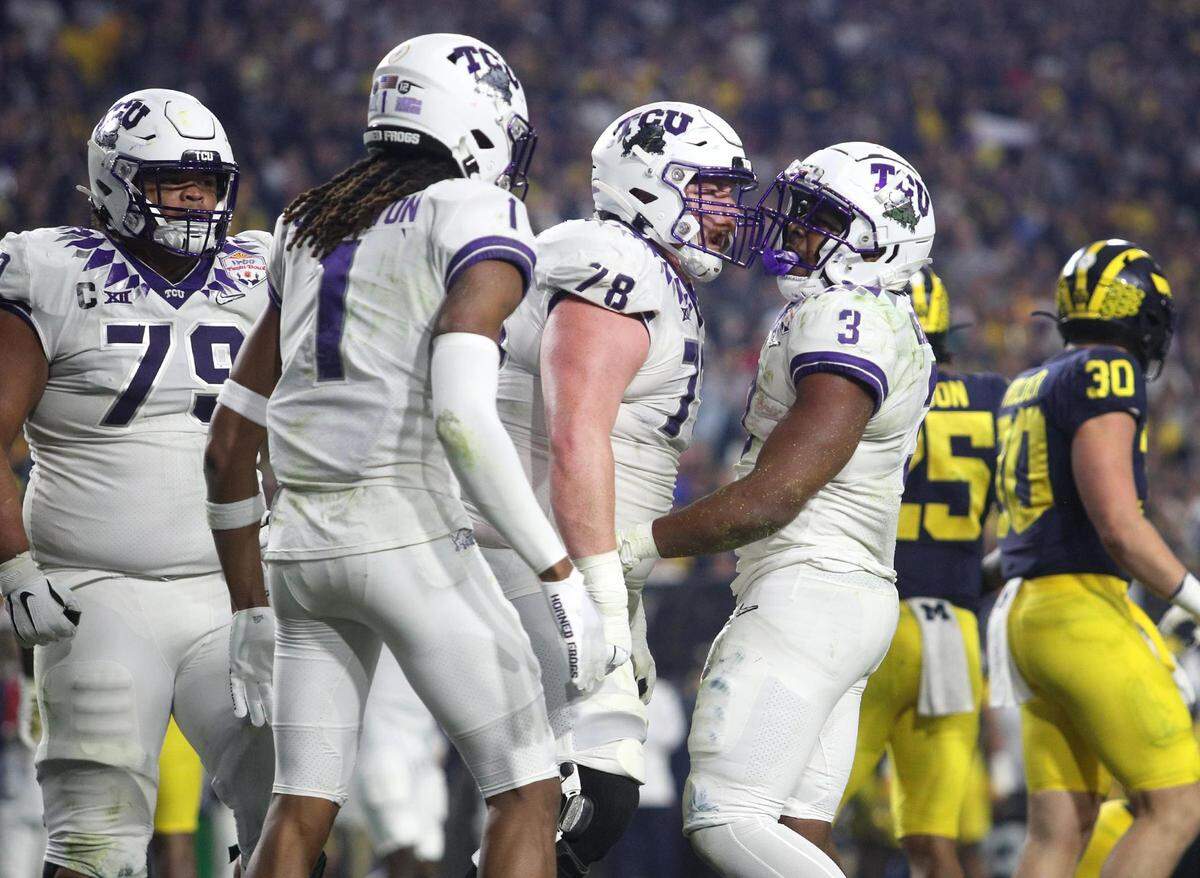 TCU teammates celebrate a touchdown by running back Emari Demercado, 3, at the Vrbo Fiesta Bowl at State Farm Stadium in Glendale, Ariz., on Saturday, December 31, 2022.