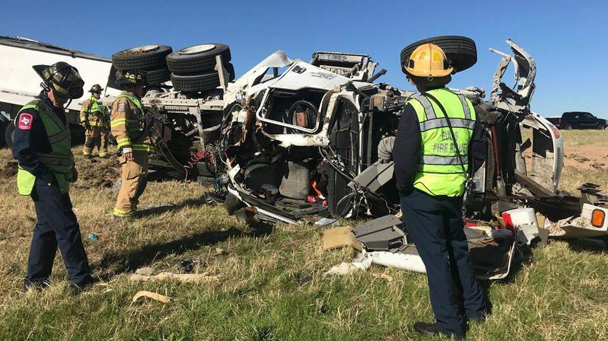 Euless firefighters investigate the rollover crash of an 18-wheeler Tuesday morning.