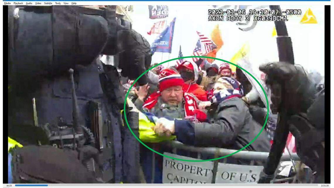 A photo in the FBI complaint shows Jalise Middleton, right, hitting an officer’s arm.