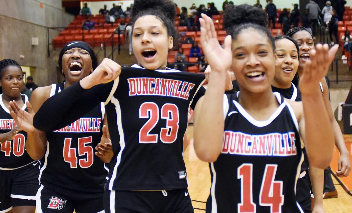 Duncanville’s Laila McLeod, left center and Kiyara Howard-Garza (14) with teammates celebrate the 47-43 win over Desoto in the Regional Quarterfinal Playoff basket ball game Tuesday, February 25, 2020 at Wilkerson Greines Activity Center in Fort Worth. Texas. Special/Bob Haynes
