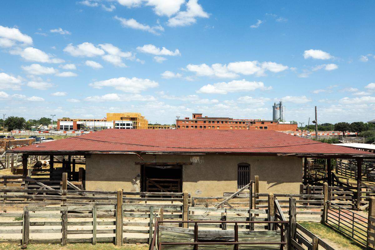 Construction of the new Kairoi Residential apartments can be seen behind the Fort Worth Stockyards cattle pens’ scalehouse seen on Tuesday, July 30, 2024.