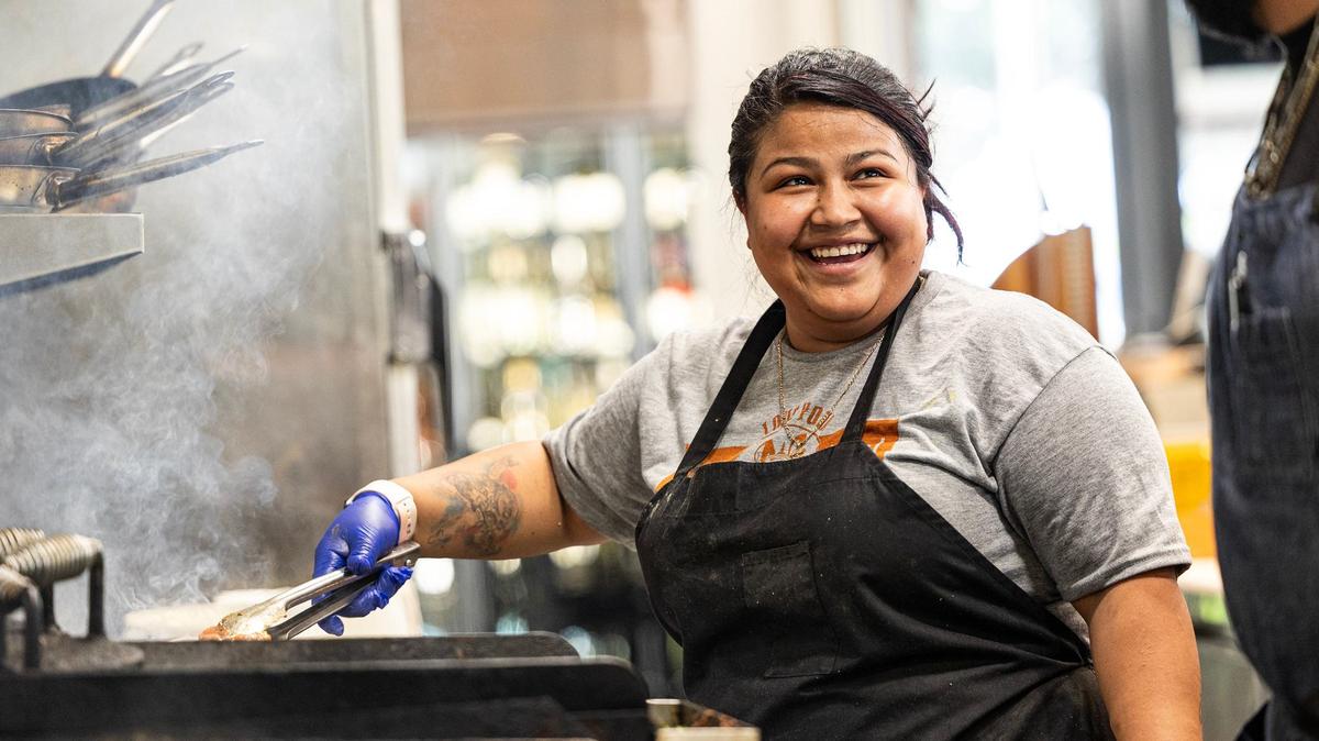 Lead cook Carolina Gomez cooks chicken in the Neighbors House restaurant in downtown Fort Worth on Thursday, Aug. 22, 2024.