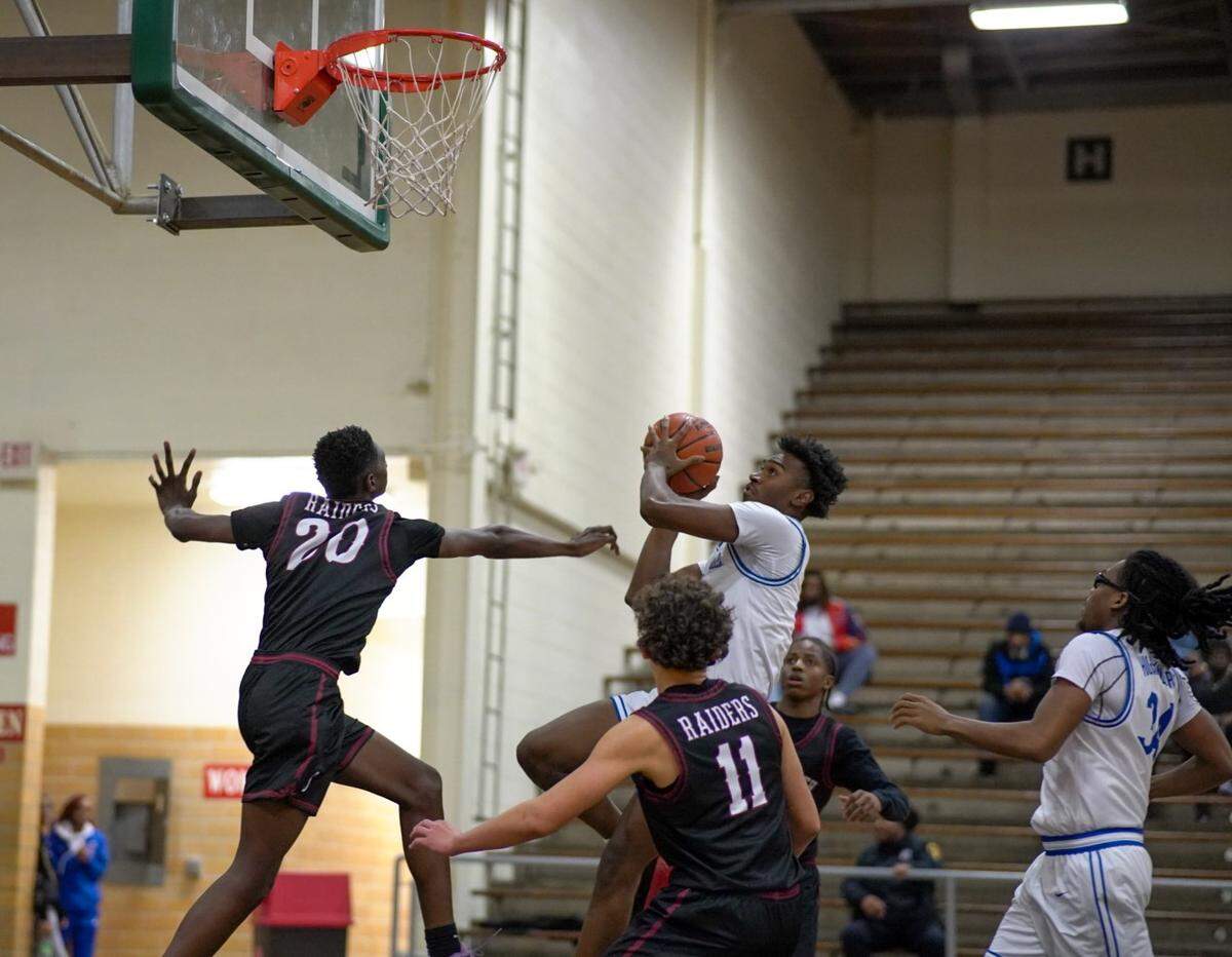 Fort Worth Eastern Hills’ Dorian Johnson goes in for a lay up challenged by Fort Worth Southwest’s King Tayor (20) and Sage Gonzalez (11) in a boys District 8-4A contest on Tuesday, January 14, 2025 at Billingsley Field House in Fort Worth, Texas.