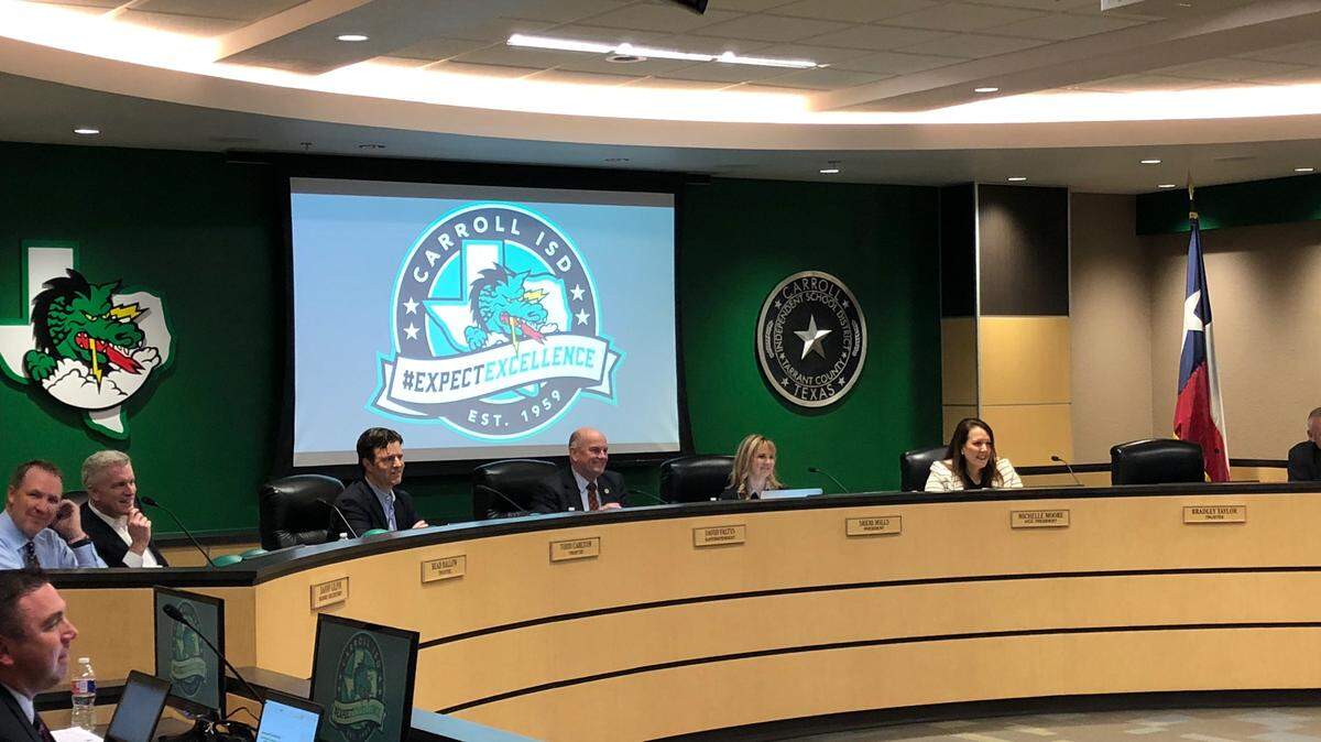 Carroll school district board of trustees, with superintendent David Faltys in front of projection screen, Feb. 26, 2018.