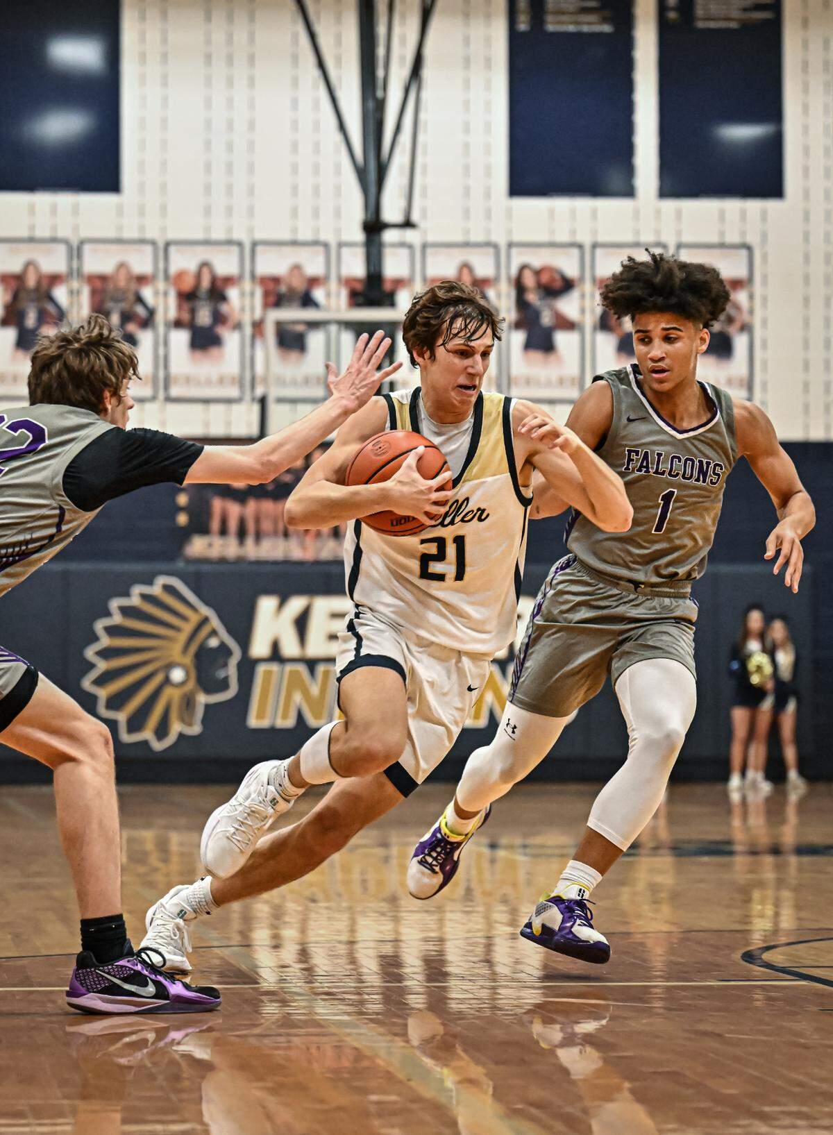 Keller’s Cash Erdmann (21) drives toward the basket against Keller Timber Creek in a District 4-6A boys basketball game on Tuesday, January 28, 2025 at Keller High School in Keller, Texas.