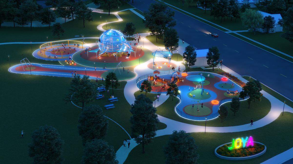 A rendering of Joya park at night which has colorful lighting features.
