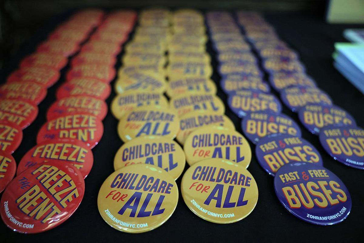Zohran Mamdani campaign buttons are seen on a table at a campaign rally  Oct. 13 in New York City. 
