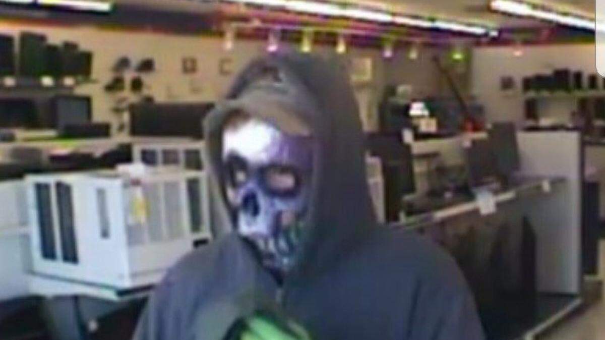 At least two pawn shops have been robbed by people wearing Halloween masks, police said.