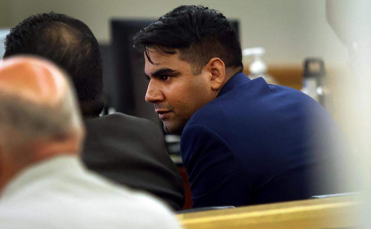 Former Arlington Police Department Officer Ravinder Singh talks with his lawyers while on trial on Tuesday, Aug. 23, 2022. Singh is accused of criminally negligent homicide in the 2019 shooting death of Margarita Brooks.