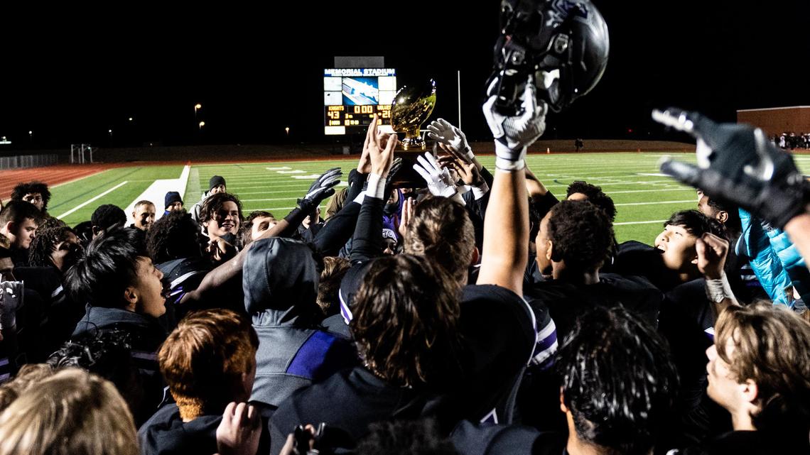 Frisco Independence celebrates with the bi-district trophy after beating Mansfield Timberview 43-28 at Memorial Stadium in Frisco, Texas, Thursday, Nov. 14, 2019.