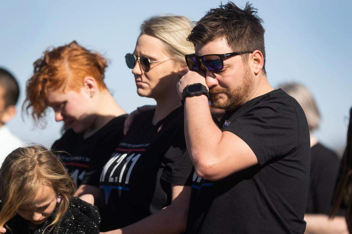 Family members grieve during a memorial a year after the deadly I-35W crash Friday, Feb. 11, 2022, at Riverside Park in Fort Worth.