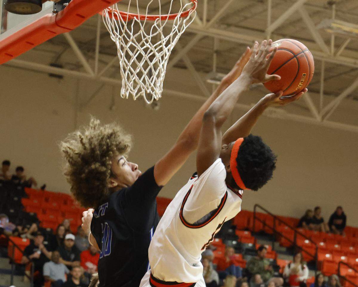 Brewer center Jayden Johnson (30) attempts to block the shot of Aledo guard Josiah Jenkins (11) during the first half of a UIL boys basketball game at Aledo High School in Aledo, Texas, Friday Feb. 13, 2026.