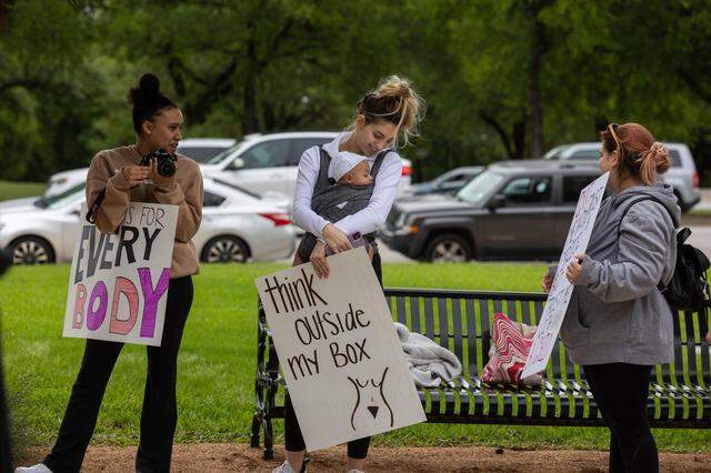 Protesters against abortion bans listen to speakers during a rally after the leaked Supreme Court opinion Tuesday, May 3, 2022, near the Tarrant County Courthouse.