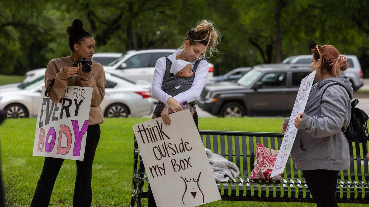 Protesters against abortion bans listen to speakers during a rally after the leaked Supreme Court opinion Tuesday, May 3, 2022, near the Tarrant County Courthouse.