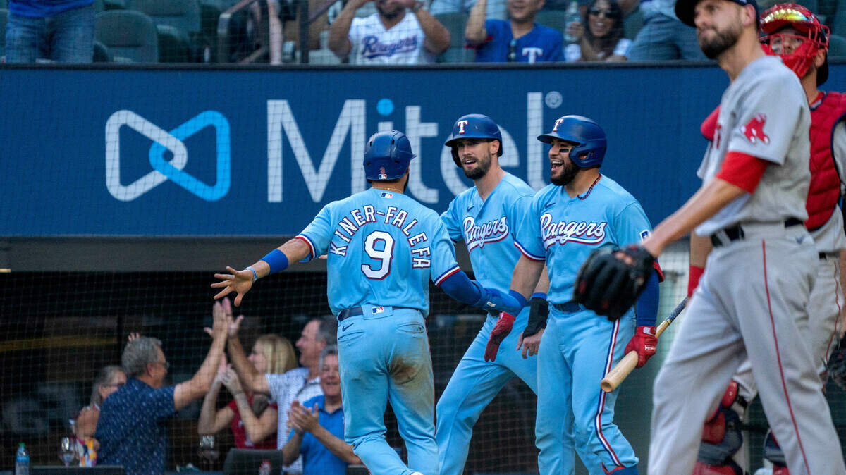 The Texas Rangers rallied for three runs in the eighth inning, including two that scored on Brock Holt’s single to center, including Isiah Kiner-Falefa, left, and David Dahl, center, who celebrated with Jose Trevino, right. The Rangers beat the Boston Red Sox 5-3 Sunday at Globe Life Field.