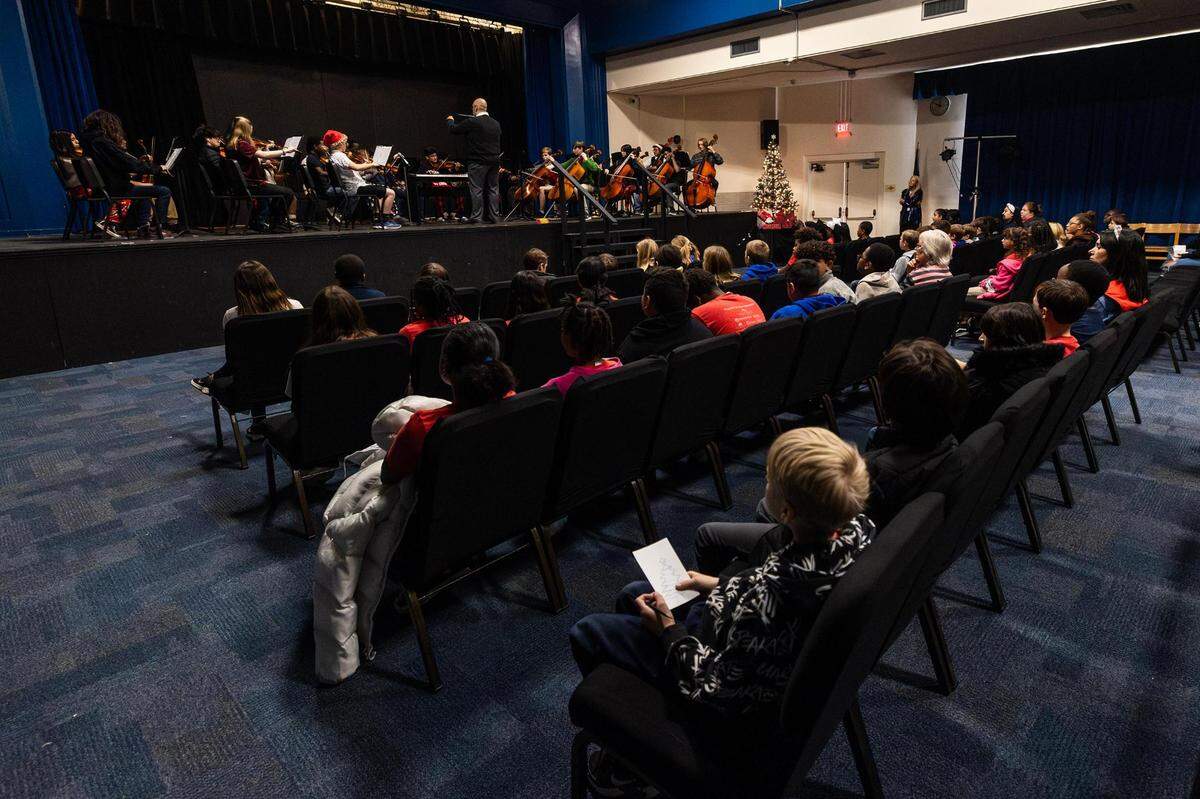 Orchestra director Julio Montañez directs his orchestra students for a concert during the Ridglea Elementary School visit at Applied Learning Academy in Fort Worth on Thursday.